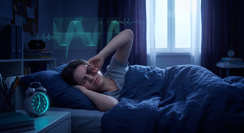 Illustration of a teenager awake in bed near an early alarm after a shortened night